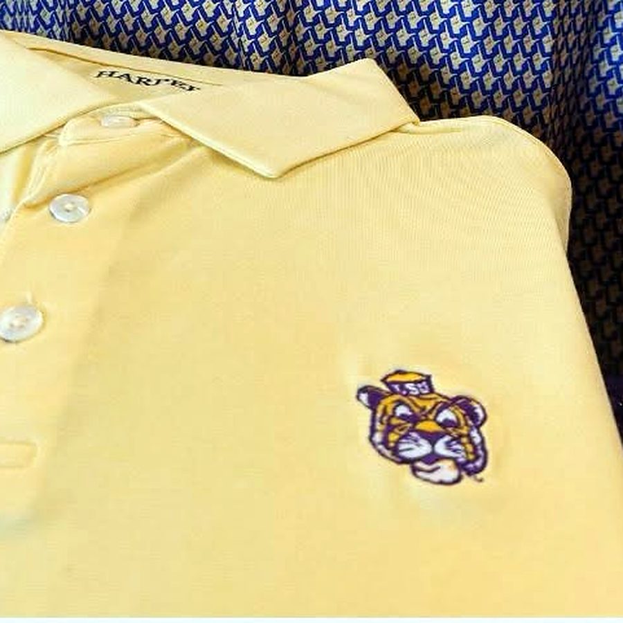 A gold Harper's polo with the LSU tiger embroidered on the chest