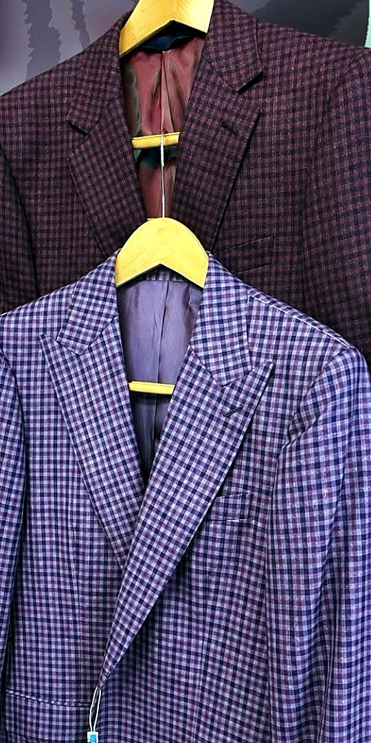 A purple check sport coat on a hanger